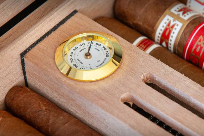 up close Hygrometer in humidor with cigars