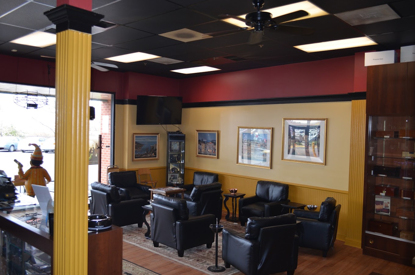 A cozy, elegant smoking lounge featuring comfortable leather chairs, framed artwork, and a welcoming atmosphere, ideal for relaxation and enjoying cigars or other leisurely pursuits in a smoking lounge.