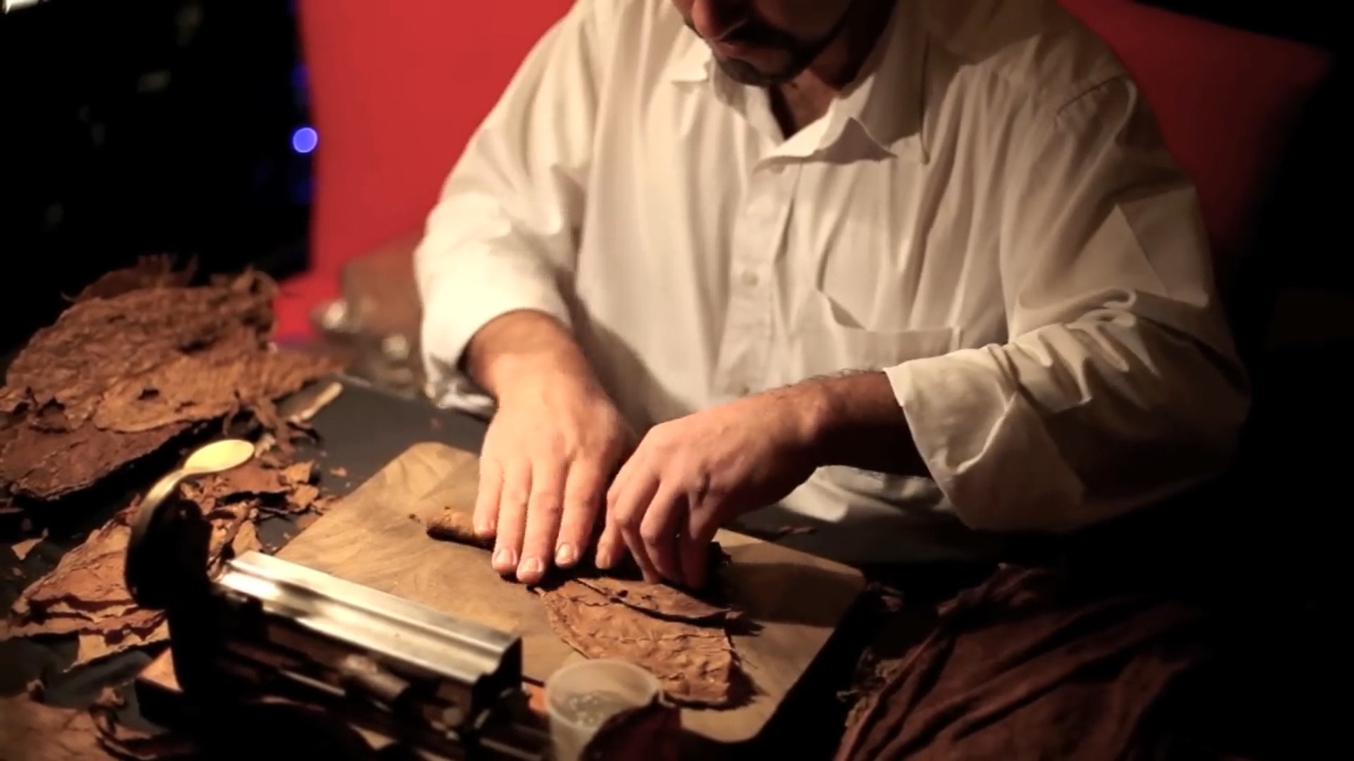 A cigar expert rolling a cigar
